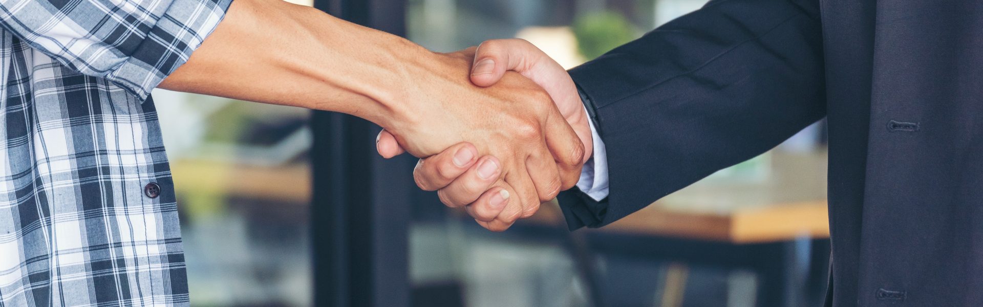 diversity,two,business,partners,shaking,hands,together,with,business,contract