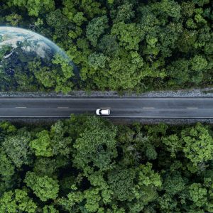 eco,car,on,forest,road,with,earth,planet,going,through