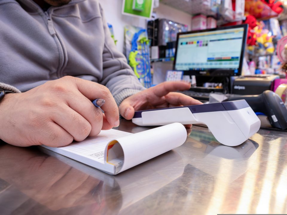 shop,owner,writes,down,tax,invoice,for,the,customer,needs